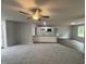 Open floor plan with a living area, kitchen island, and modern lighting at 163 Oakfield Trace Dr, Four Oaks, NC 27524