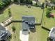 Aerial view of a large backyard featuring a playset, garden, and lush greenery at 180 Packhouse Ct, Angier, NC 27501
