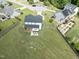 Aerial view showing the home, fenced backyard, patio area, and surrounding landscape at 180 Packhouse Ct, Angier, NC 27501