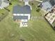 Aerial view of a house highlighting the expansive backyard, patio area, and well-kept lawn at 180 Packhouse Ct, Angier, NC 27501