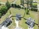 Overhead view of a large lot with a spacious backyard, play area, and mature trees at 180 Packhouse Ct, Angier, NC 27501