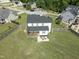 Aerial view of a home showcasing the spacious backyard, patio, and surrounding neighborhood at 180 Packhouse Ct, Angier, NC 27501