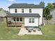 Aerial view of the backyard featuring a deck, patio, and spacious lawn at 180 Packhouse Ct, Angier, NC 27501