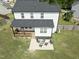 Aerial view of the backyard featuring a deck, patio, and spacious lawn at 180 Packhouse Ct, Angier, NC 27501