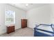 Cozy bedroom featuring neutral walls and carpet with a crib, dresser, and bright window at 180 Packhouse Ct, Angier, NC 27501