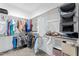 Bright walk-in closet with organized shelving and hanging storage for clothes and accessories at 180 Packhouse Ct, Angier, NC 27501