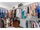 Walk-in closet with an abundance of clothing, a wood chest, and multiple levels of shelving at 180 Packhouse Ct, Angier, NC 27501