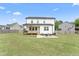 Exterior view of the home's back featuring a deck, patio, and spacious backyard at 180 Packhouse Ct, Angier, NC 27501