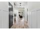 Inviting hallway with wood-look floors and wainscoting that leads into the living room at 180 Packhouse Ct, Angier, NC 27501