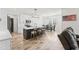 Open-concept kitchen featuring an island with bar seating, stainless steel appliances, and a connecting dining area at 180 Packhouse Ct, Angier, NC 27501