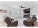 Comfortable living room with a fireplace, a ceiling fan, a large rug, and two leather recliner chairs at 180 Packhouse Ct, Angier, NC 27501