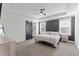 Main bedroom features a sliding barn door, tray ceiling, a ceiling fan, and lots of natural light at 180 Packhouse Ct, Angier, NC 27501