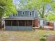 Backyard view of two-story home featuring a screened porch, deck, and lawn at 1809 Glendale Ave, Durham, NC 27701