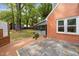 Backyard featuring a deck, patio, and lush landscaping surrounding the home at 1809 Glendale Ave, Durham, NC 27701