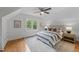 Bright bedroom featuring hardwood floors, ceiling fan, and natural light from double windows at 1809 Glendale Ave, Durham, NC 27701