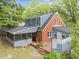 An inviting two-story home featuring a brick facade, charming screened porch, and a stylish wooden deck at 1809 Glendale Ave, Durham, NC 27701