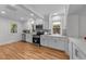 Modern white kitchen with stainless steel appliances, ample counter space, and hardwood floors at 1809 Glendale Ave, Durham, NC 27701