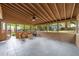 Spacious sunroom with wood-paneled ceiling, ceiling fan and slate floors at 1809 Glendale Ave, Durham, NC 27701