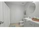 Neutral bathroom features a vanity, mirror, and toilet, complemented by neutral tile flooring at 1832 Elkpark Dr, Raleigh, NC 27610