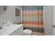 Bathroom features a modern vanity and toilet, highlighted by a colorful patterned shower curtain at 1832 Elkpark Dr, Raleigh, NC 27610
