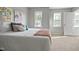 Bright bedroom featuring carpeted floors and 2 large windows at 1832 Elkpark Dr, Raleigh, NC 27610