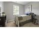Cozy bedroom with a window, dresser, and comfortable bed, perfect for relaxing at 1832 Elkpark Dr, Raleigh, NC 27610