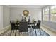 Contemporary dining room featuring modern decor, lighting, and an accent wall at 1832 Elkpark Dr, Raleigh, NC 27610