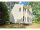 Side view of a charming two-story home with well-maintained lawn and lush landscaping at 1832 Elkpark Dr, Raleigh, NC 27610