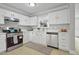 Updated kitchen with modern appliances, ample counter space, and plenty of natural light at 1832 Elkpark Dr, Raleigh, NC 27610