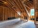 Unfinished attic space with exposed framing, providing potential for customization and expansion at 200 Larkhaven Pl, Apex, NC 27539