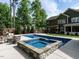 Spacious backyard featuring an in-ground pool, spa, patio, and lush green landscaping at 200 Larkhaven Pl, Apex, NC 27539