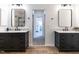 Elegant bathroom featuring dual vanities with granite countertops and modern fixtures at 200 Larkhaven Pl, Apex, NC 27539