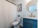 Stylish bathroom features a patterned floor, blue vanity, framed print and white shower curtain at 200 Larkhaven Pl, Apex, NC 27539