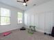 Bright bedroom with natural light, ceiling fan, and space for exercise equipment at 200 Larkhaven Pl, Apex, NC 27539