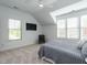 Bedroom with sloped ceilings, neutral color palette, plush carpet, ceiling fan, and natural lighting at 200 Larkhaven Pl, Apex, NC 27539