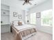 Comfortable bedroom with a ceiling fan, built in shelves, two windows, and neutral decor at 200 Larkhaven Pl, Apex, NC 27539