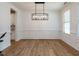 Elegant dining room features hardwood floors, white trim and decorative lighting at 200 Larkhaven Pl, Apex, NC 27539