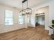 Bright, spacious dining room features stylish lighting and hardwood flooring at 200 Larkhaven Pl, Apex, NC 27539