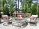 Backyard stone firepit area with comfortable seating, perfect for outdoor entertaining at 200 Larkhaven Pl, Apex, NC 27539