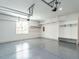 Clean and organized garage with painted floor, built-in shelving, and ample storage space at 200 Larkhaven Pl, Apex, NC 27539