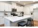 Kitchen featuring white cabinets, stainless steel appliances, and a large center island with seating at 200 Larkhaven Pl, Apex, NC 27539