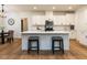 Bright kitchen with white cabinets, stainless steel appliances, and a large center island at 200 Larkhaven Pl, Apex, NC 27539