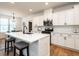 Kitchen featuring white cabinets, stainless steel appliances, a center island, and dining area at 200 Larkhaven Pl, Apex, NC 27539