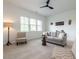 Inviting living room with cozy furniture, movie decor, and natural light from the windows at 200 Larkhaven Pl, Apex, NC 27539