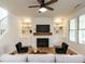 Bright living room featuring fireplace with a wooden mantle and built-in bookcases at 200 Larkhaven Pl, Apex, NC 27539