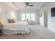 Bright main bedroom with a tray ceiling, large windows, and plush carpeting at 200 Larkhaven Pl, Apex, NC 27539