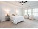 Bright main bedroom with a tray ceiling, large windows, and plush carpeting at 200 Larkhaven Pl, Apex, NC 27539