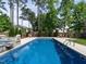 Inviting in-ground pool with ladder and meticulously maintained yard, perfect for outdoor enjoyment at 200 Larkhaven Pl, Apex, NC 27539