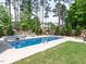 Relaxing backyard oasis with a sparkling in-ground pool, spa, and lush landscaping at 200 Larkhaven Pl, Apex, NC 27539