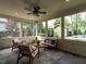 Relaxing screened porch with stone flooring, a ceiling fan, wood furniture and a view of the pool at 200 Larkhaven Pl, Apex, NC 27539